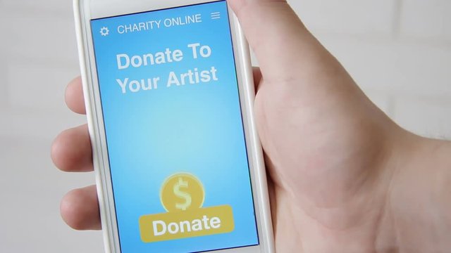 Man making an online donation to his favorive artist using charity applicaiton on smartphone