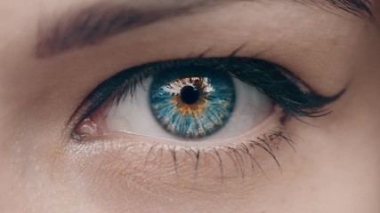 Young Woman is opening and closing her beautiful eye. Macro Close-up eye blinking.