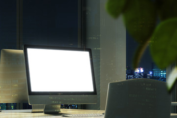 Blank computer screen in a night office