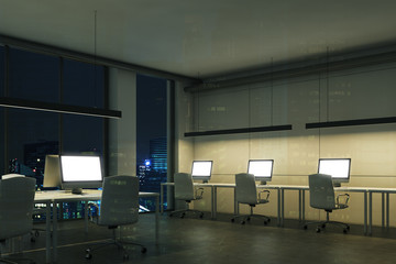 Blank computer screens in a night office, corner