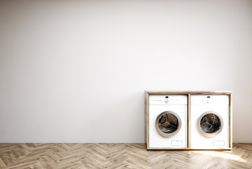 Gray room with two washing machines, wooden floor