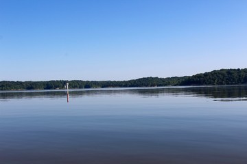 The view of the lake at the waters edge on the beach. 