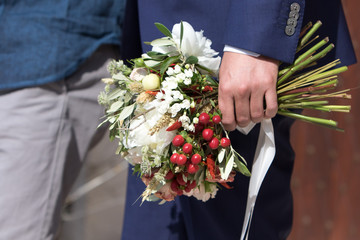 Bouquet in the hand of the groom
