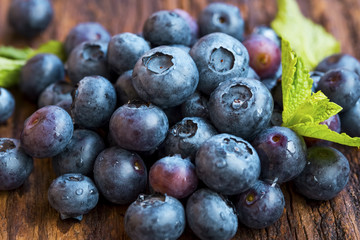 Closeup of blueberries heap on wooden background