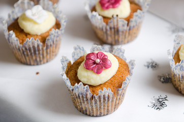 Beautiful inviting Sponge and cream cup cakes with a shallow depth of field, photographed on a table.