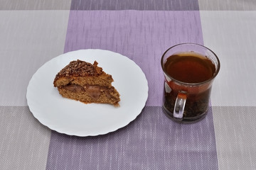 piece of cake and a glass of tea on the table