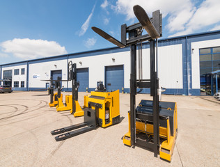 london, england, 10/05/ 2016 Big vivid yellow modern pedestrian forklift machines. Pedestrian...