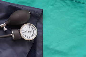 Blood pressure device located on the hospital green background.