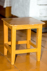 A small Russian stool, painted in orange.