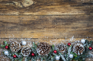 Christmas background with natural ornament and christmas balls on brown wooden boards