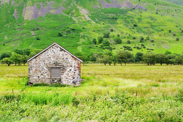 Fototapeta premium Old stone barn in the field, Lake District National Park, Cumbria, England, selective focus