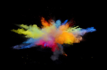 Multi color explosions of powder paint create abstract forms in front of a black background giving...