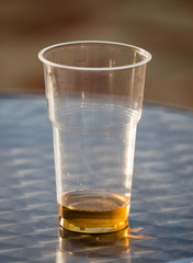Beer in a plastic glass on the table
