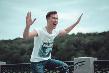 A man is riding a bicycle in a park on the waterfront