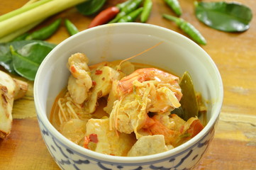 spicy shrimp and fish tom yum soup in bowl