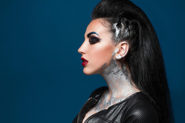 Girl with creative make-up on a blue background