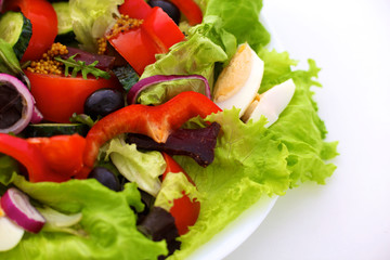 salad from fresh vegetables in a plate on a table, selective focus
