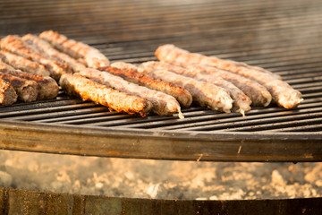 Sausages are fried on a barbecue