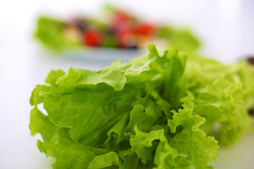 salad from fresh vegetables in a plate on a table, selective focus