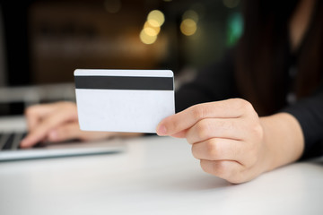 asian young woman hands holding credit card and using laptop smart phone Online shopping.Online shopping concept