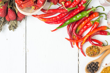 fresh chilli peppers, various kinds on white, space for advertising text, selective focus 