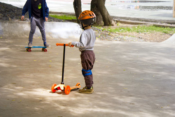 little boy riding scooter in the city, kids sport