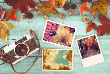 Fototapeta na wymiar Photo album in remembrance and nostalgia in autumn (fall season) on wood table. instant photo of retro camera - vintage and retro style