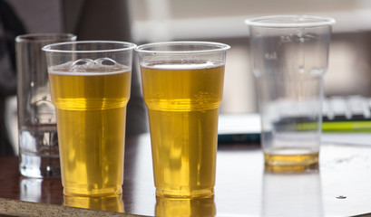 Beer in a plastic glass on the table