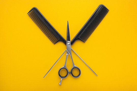 Hair cutting shears on yellow background