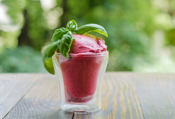 Raspberry Ice Cream, summer sundae with fresh fruits on wooden background.