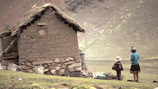 Quechua native children outside of the houses in the Andean mountains of Peru.