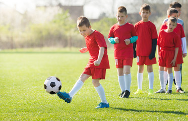 Kids soccer football - children players match on soccer field