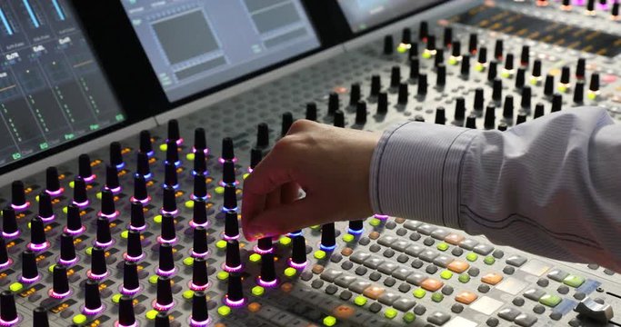 Hands of Audio engineer working. Professional audio mixer, sound engineer, producer control engineer, audio mixing console