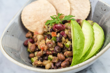 Legumes salad with crackers and avocado