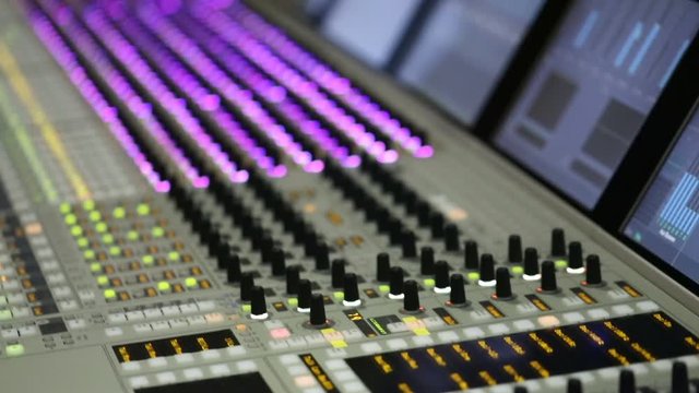  Professional audio mixer. A small depth of field, flickering light bulbs.Hands of Audio engineer working. Sound engineer, producer control engineer, audio mixing console