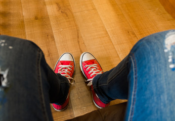 Sat on the sofa and took photo of my red sneakers on wooden floor