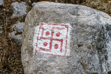 Swastika sign on grey stone at Thangu and Chopta valley in winter in Lachen. North Sikkim, India.