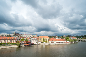 View of building along Vltava River, from Charles Bridge in Prague, Czech Republic.