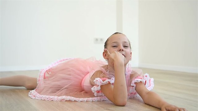 Ballerina Girl Is Tired And Lies On Floor
