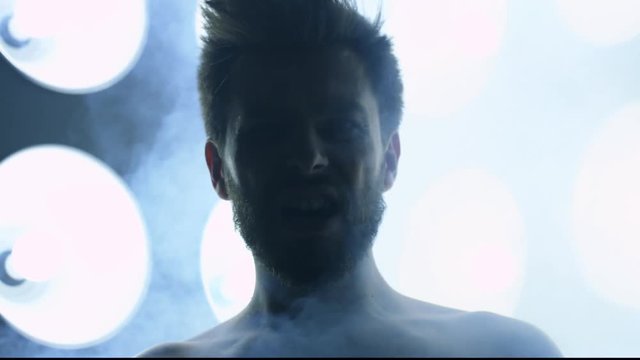 Screaming man in front of big disco lights, Red Epic 120fps slow motion 4k clip