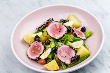 Raw and fresh tuna meat with sesame and fresh vegetable salad