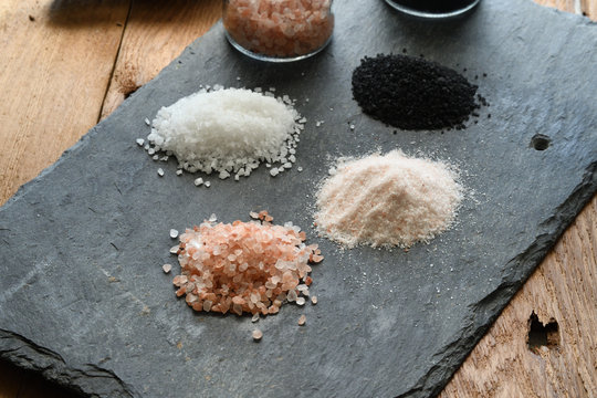 Variety of Gourmet Sea Salt - Pink Himalayan, Black Lava and White on a Slate board - Powered by Adobe