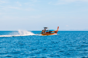 Long tail boat sailing on the blue sea