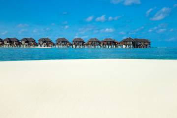 beach with water bungalows at Maldives