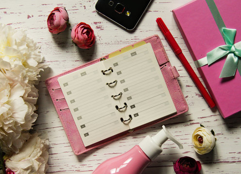 Top View Of Open Notebook And Pink Accessories