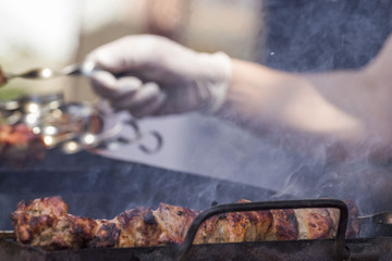 Cooking juicy meat shish kebab on the skewer close