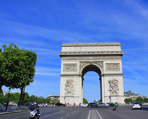 Fototapeta na wymiar Arc de Triomphe popular top attraction in city of Paris, France. View from Champs Elysees street to Place Charles de Gaulle. Beautiful summer day scene with clear blue sky background.