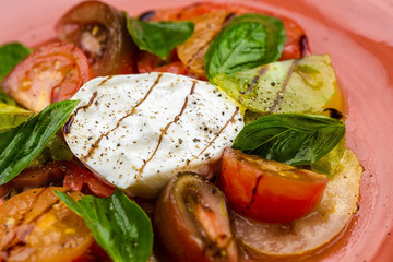 Caprese salad Tomato and mozzarella slices with basil