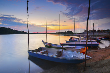 Fototapeta premium A row of fisherman boat at the river during sunset.
