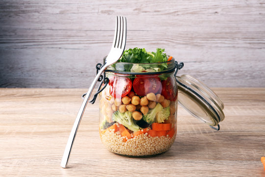 Homemade salad in glass jar with quinoa and vegetables. Healthy food, diet, detox, clean eating and vegetarian concept
